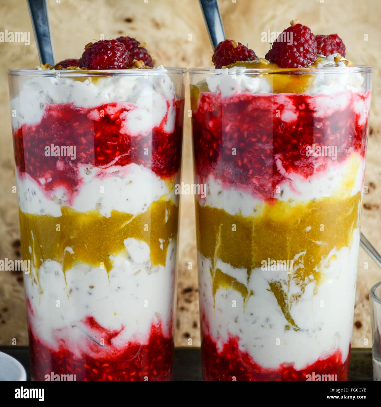 Cranachan - A Scottish dessert made with whipped cream, whisky-soaked toasted oats, pureed raspberries and (in this case) greengages. Stock Photo
