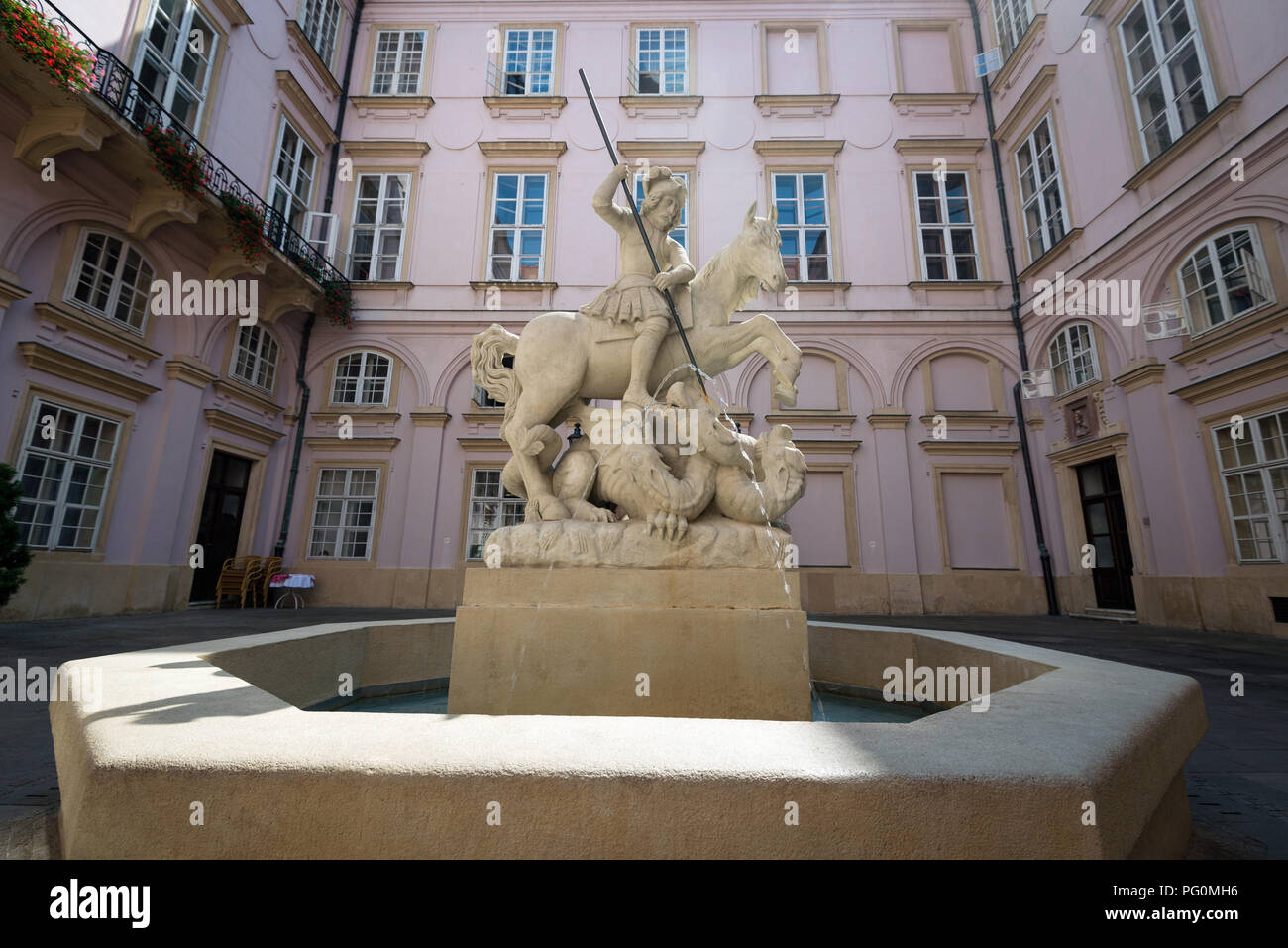 BRATISLAVA, SLOVAKIA - AUGUST 21, 2018: Fountain of Saint George and dragon at Primate Palace courtyard. Palace was built from 1778 to 1781. Today it  Stock Photo