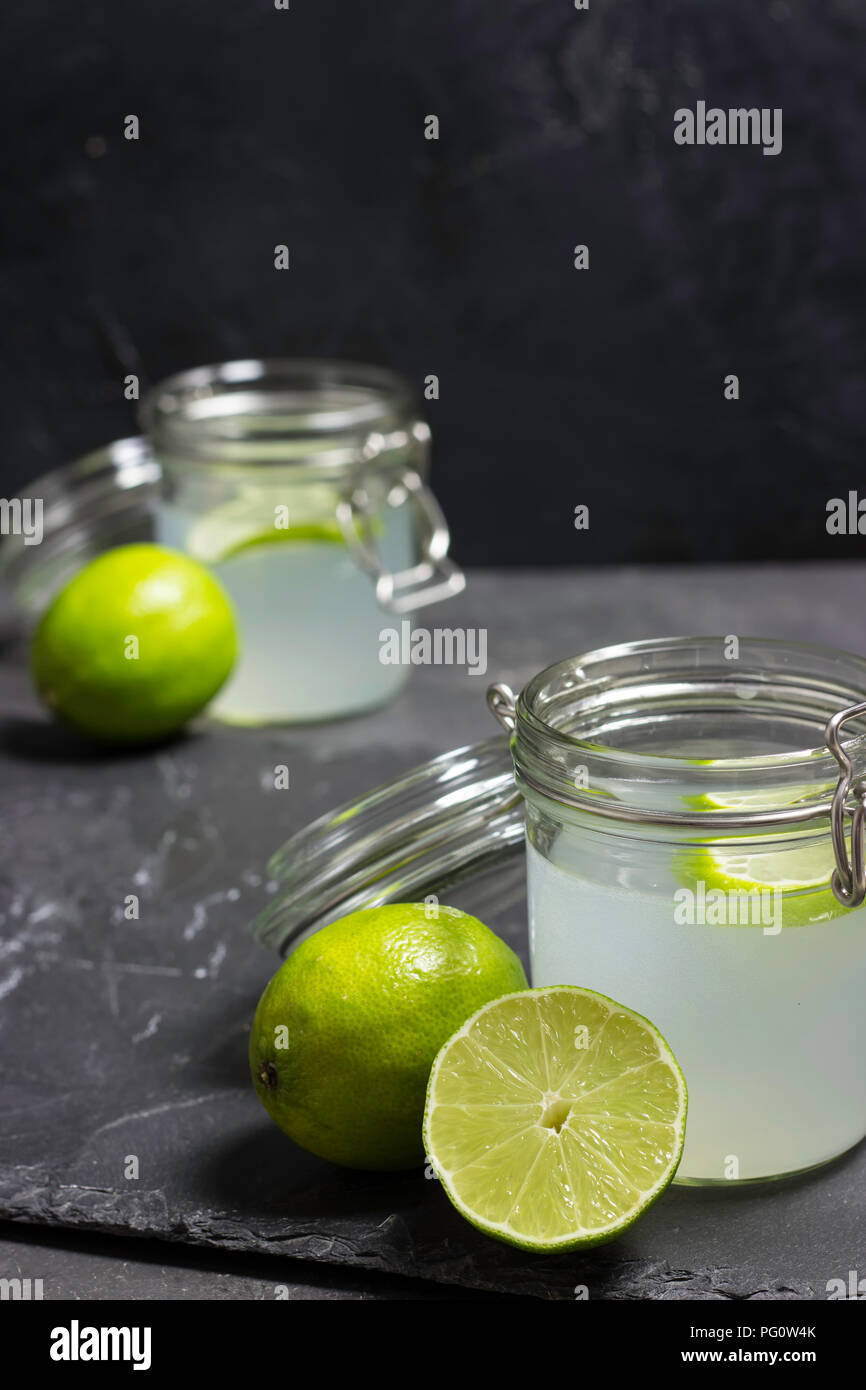 lime juice in glasses on dark stone Stock Photo