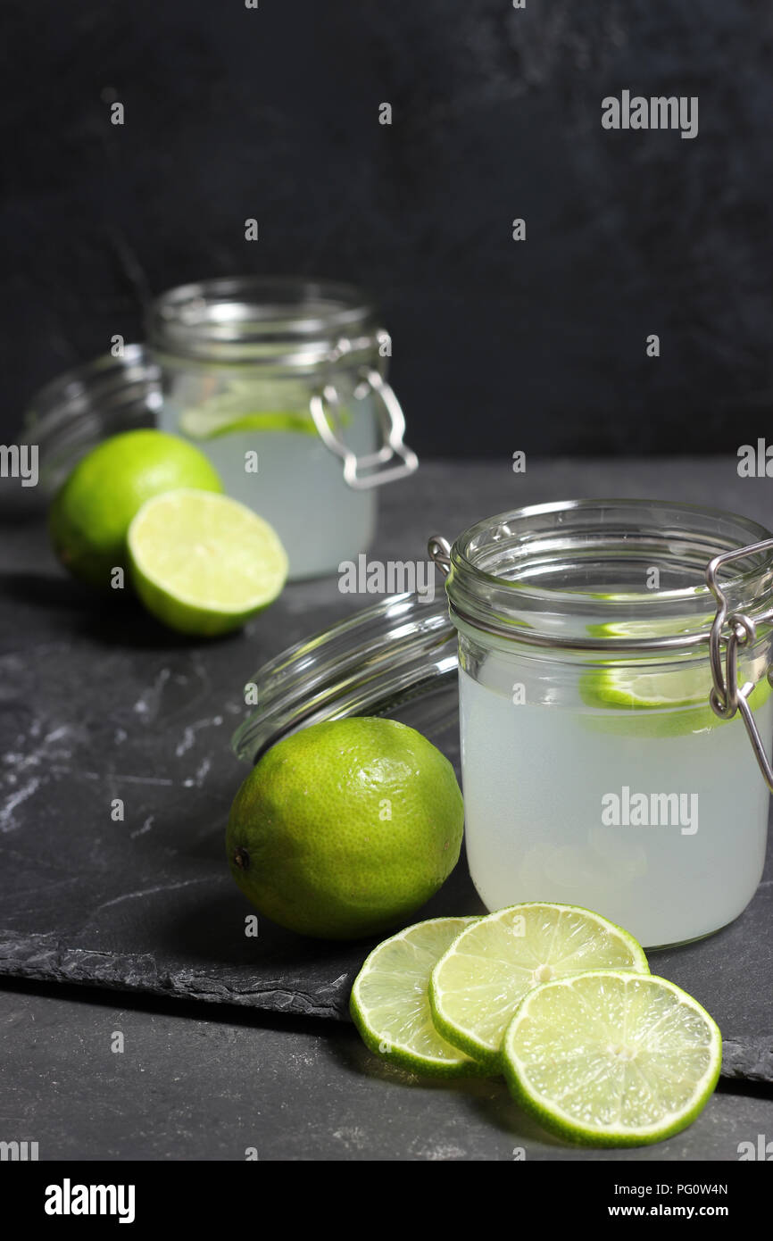 lime juice in glasses on dark stone background Stock Photo