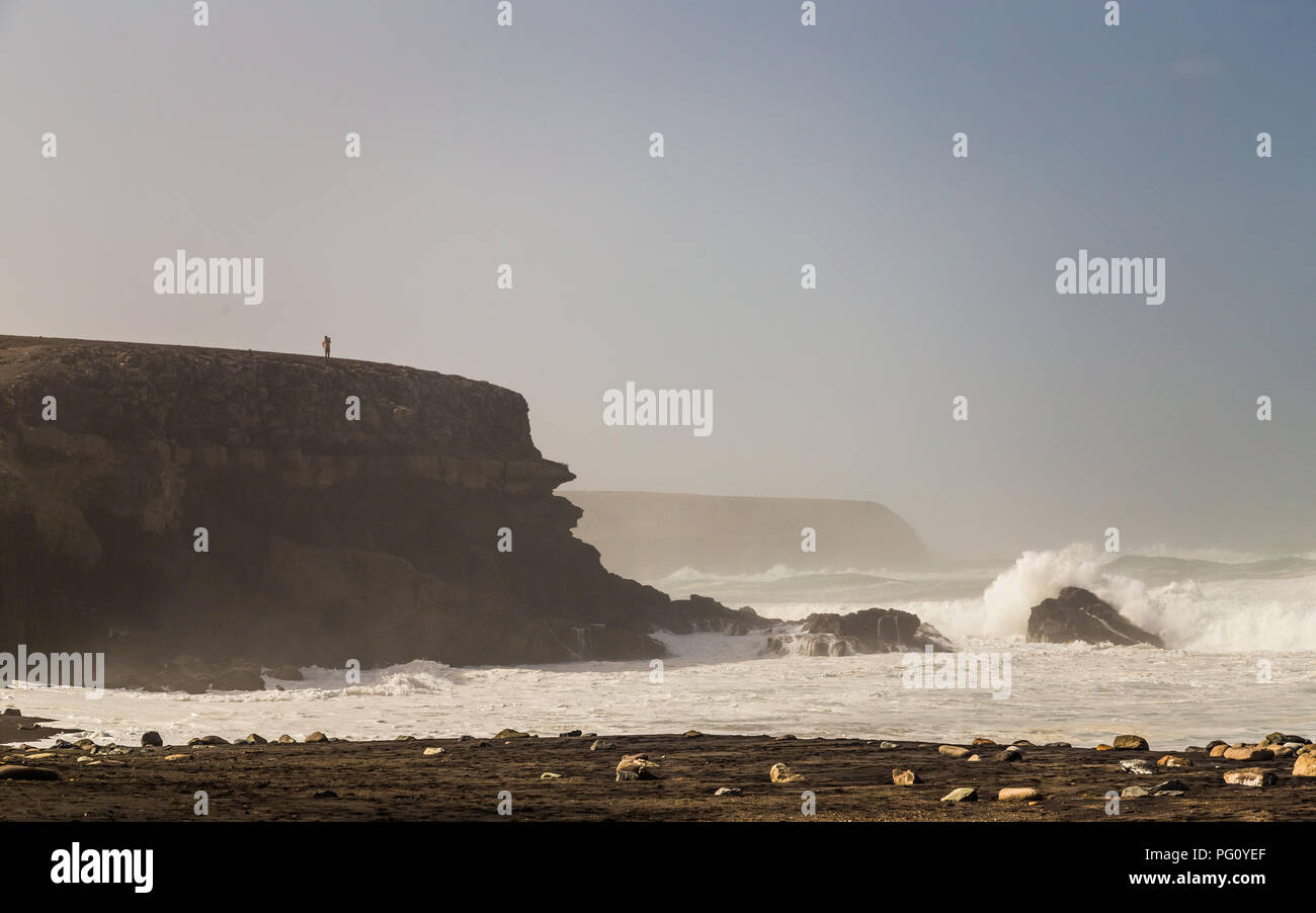 Person standing on cliff in Ajuy in Fuerteventura, Canary Islands, Spain. Stock Photo