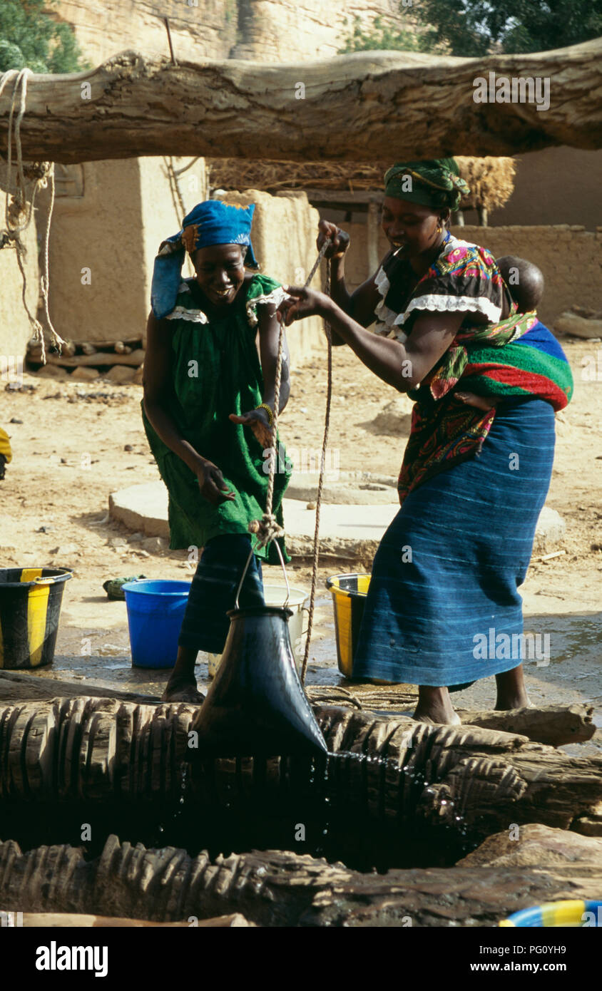 Women drawing water from the well in Kani Kombole village, Dogon country, Mali                FOR EDITORIAL USE ONLY Stock Photo