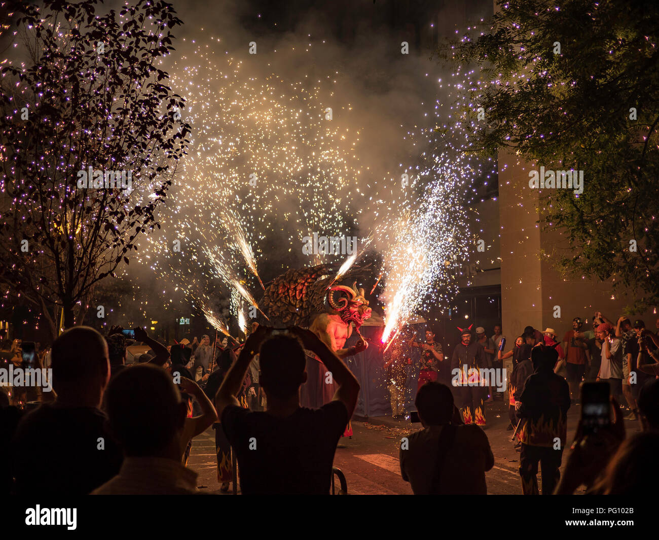 Barcelona, Spain. August 22, 2018 - People celebrating in the Fire Run 'Correfoc' ritual in Gracia Festival in Barcelona Stock Photo