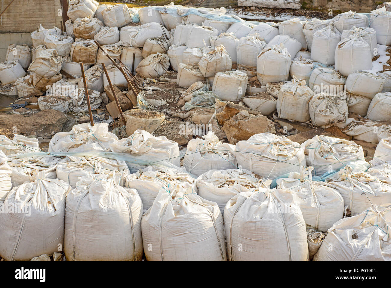 Lot of big white sandbags for flood defense. Stock Photo