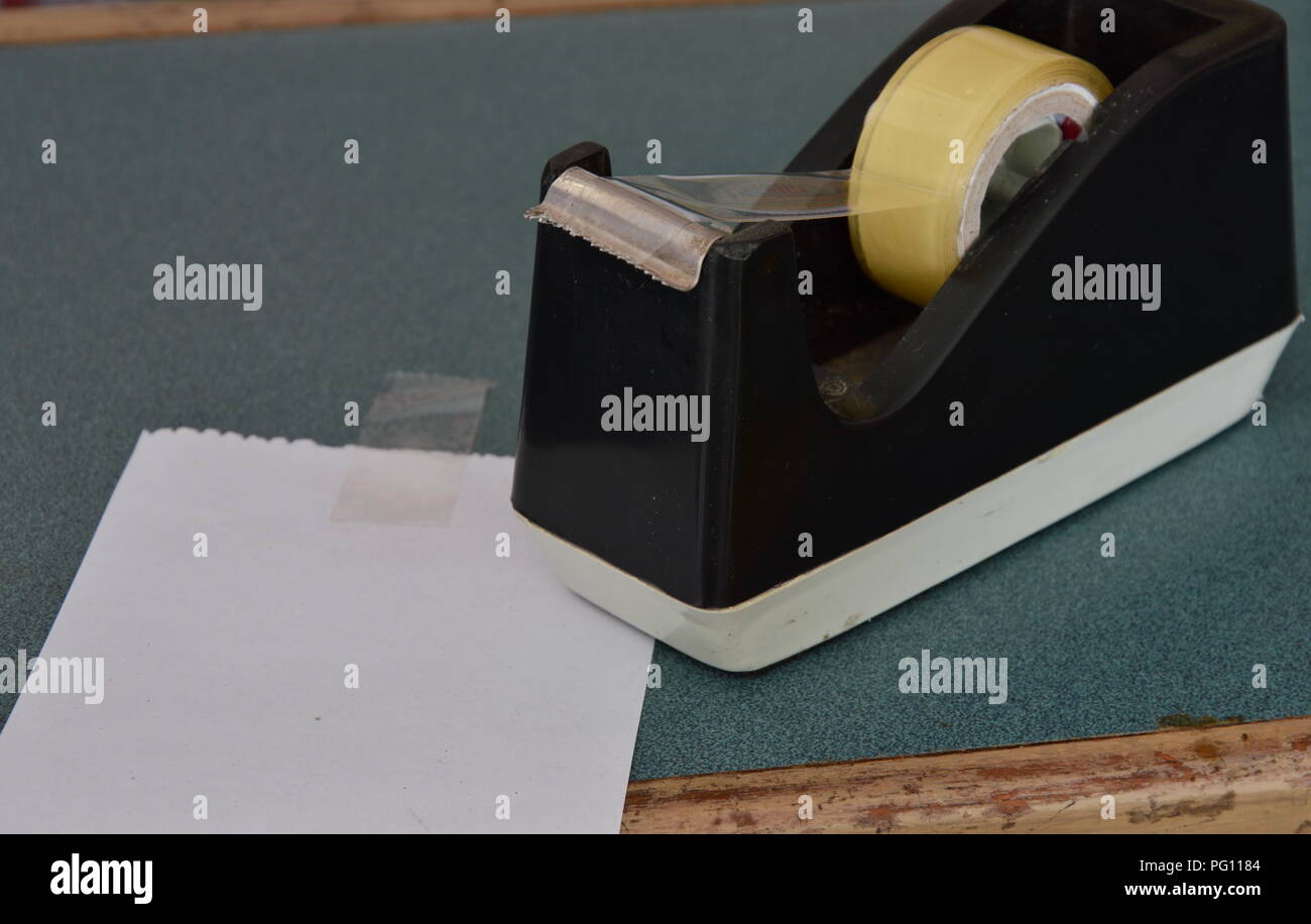 tape dispenser and paper note on counter cashier in shop Stock Photo