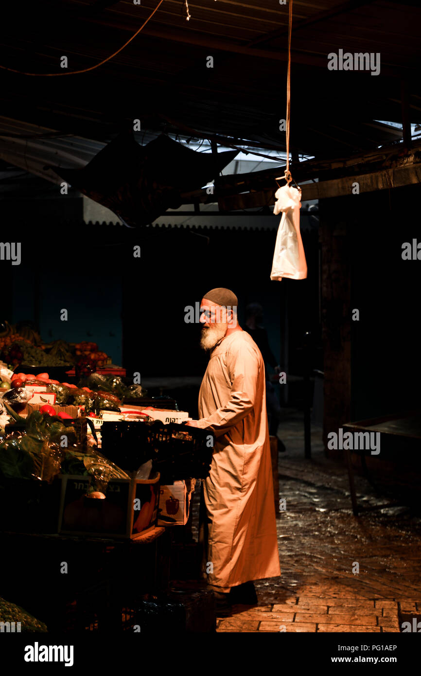 Arab market trader at closing time in Akko, Israel Stock Photo