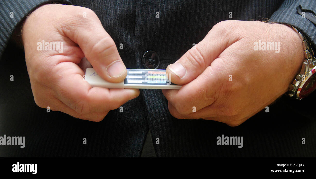 Multi panel drug test device on hand man . Stock Photo