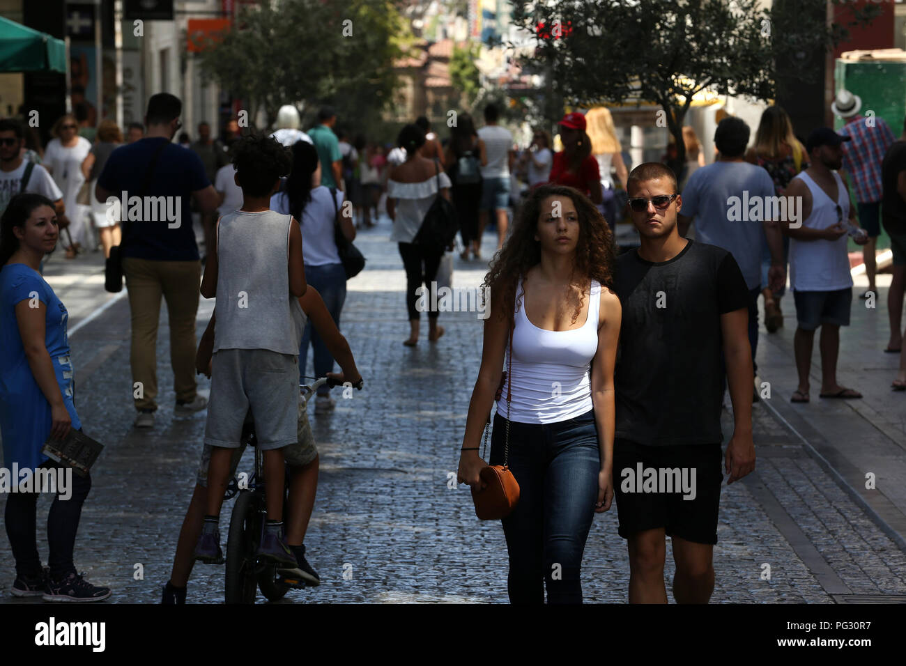 Athens, Greece. 22nd Aug, 2018. People walk on a commercial street of Athens, Greece, on Aug. 22, 2018. Greek retailing welcomed Monday's milestone of Greece's exit from the international rescue financing programs with mixed feelings of optimism and concern for the future. TO GO WITH Feature: Greek retailing welcomes end of bailouts with optimism, concern for future Credit: Marios Lolos/Xinhua/Alamy Live News Stock Photo