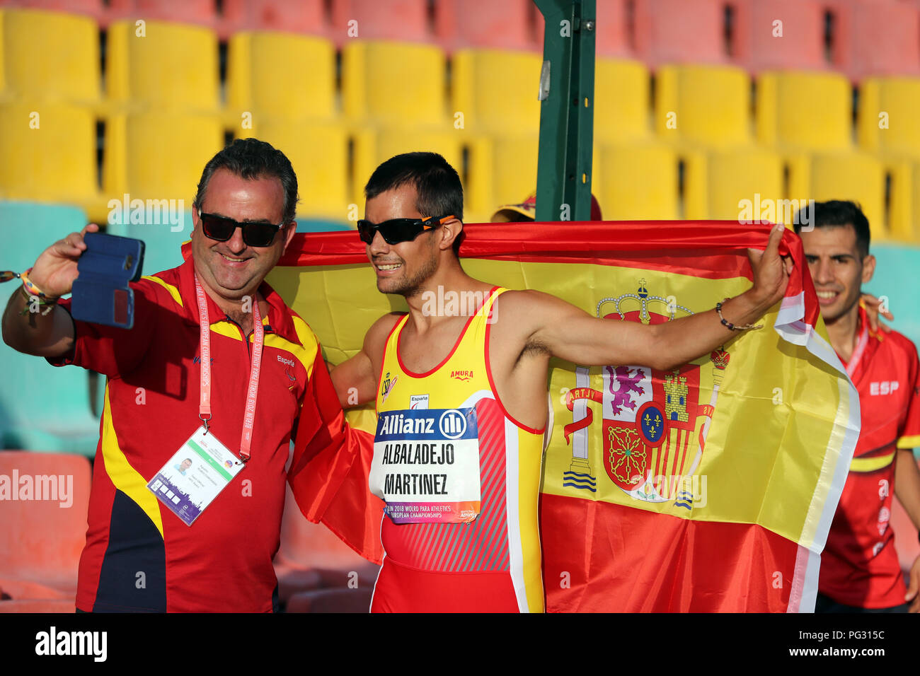 Berlin, Germany. 22nd Aug, 2018. Disabled sports, European Championships for athletes in the Jahn-Sportpark, 400 meters, men, T38. Lorenzo Albaladejo Martinez (r) wins the race and celebrates with a coach. Credit: Jens Büttner/dpa-Zentralbild/dpa/Alamy Live News Stock Photo