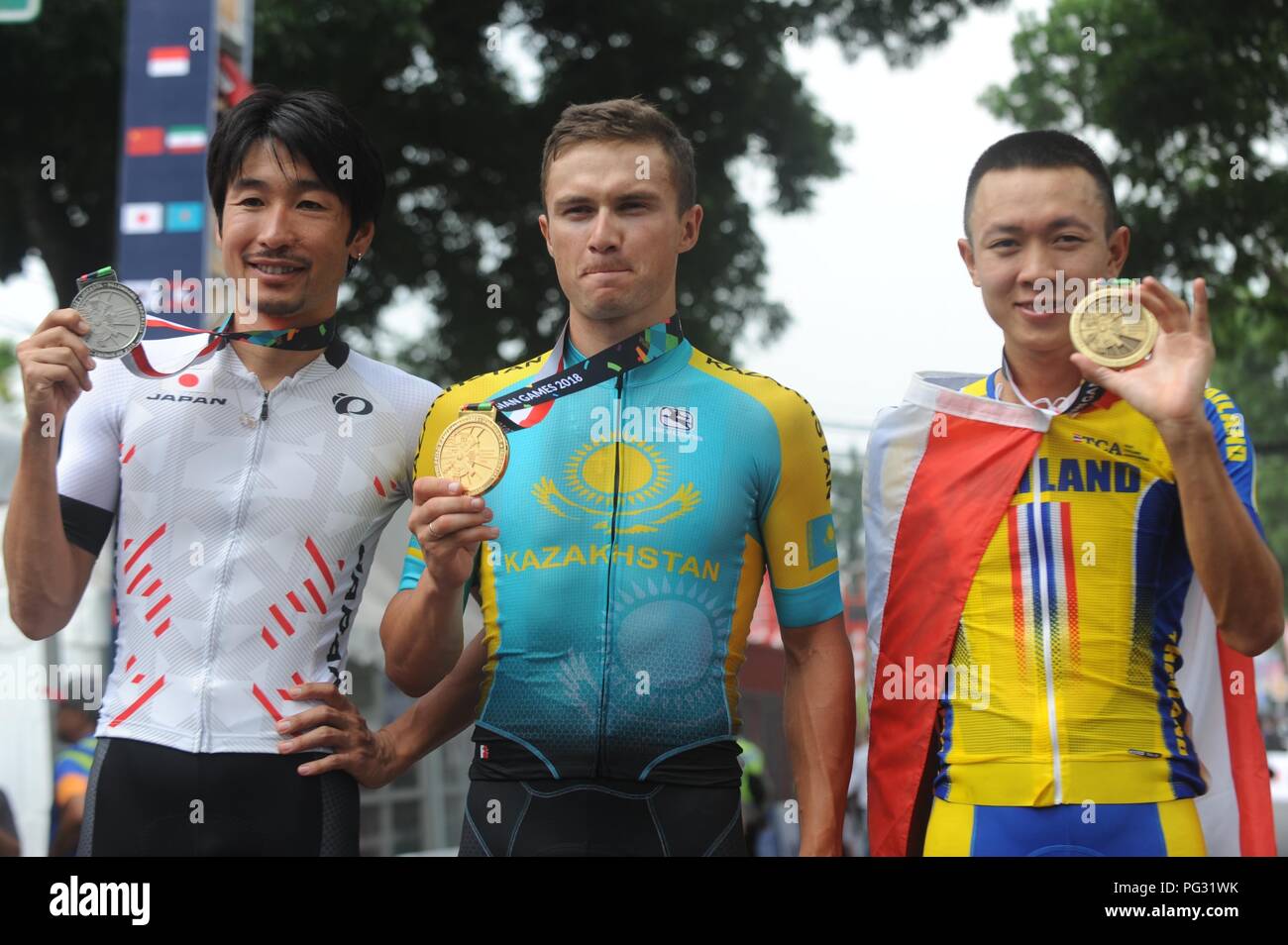 Subang, West Java. 23rd Aug, 2018. Silver medalist Beppu Fumiyuki of Japan, gold medalist Alexey Lutsenko of Kazakhstan and bronze medalist Navuti Liphongyu of Thailand (L-R) pose for photos after awarding ceremony of the men's 150 km individual road race of cycling road event at the 18th Asian Games 2018 in Subang, West Java, Indonesia. Aug. 23, 2018. Credit: Agung Kuncahya B./Xinhua/Alamy Live News Stock Photo