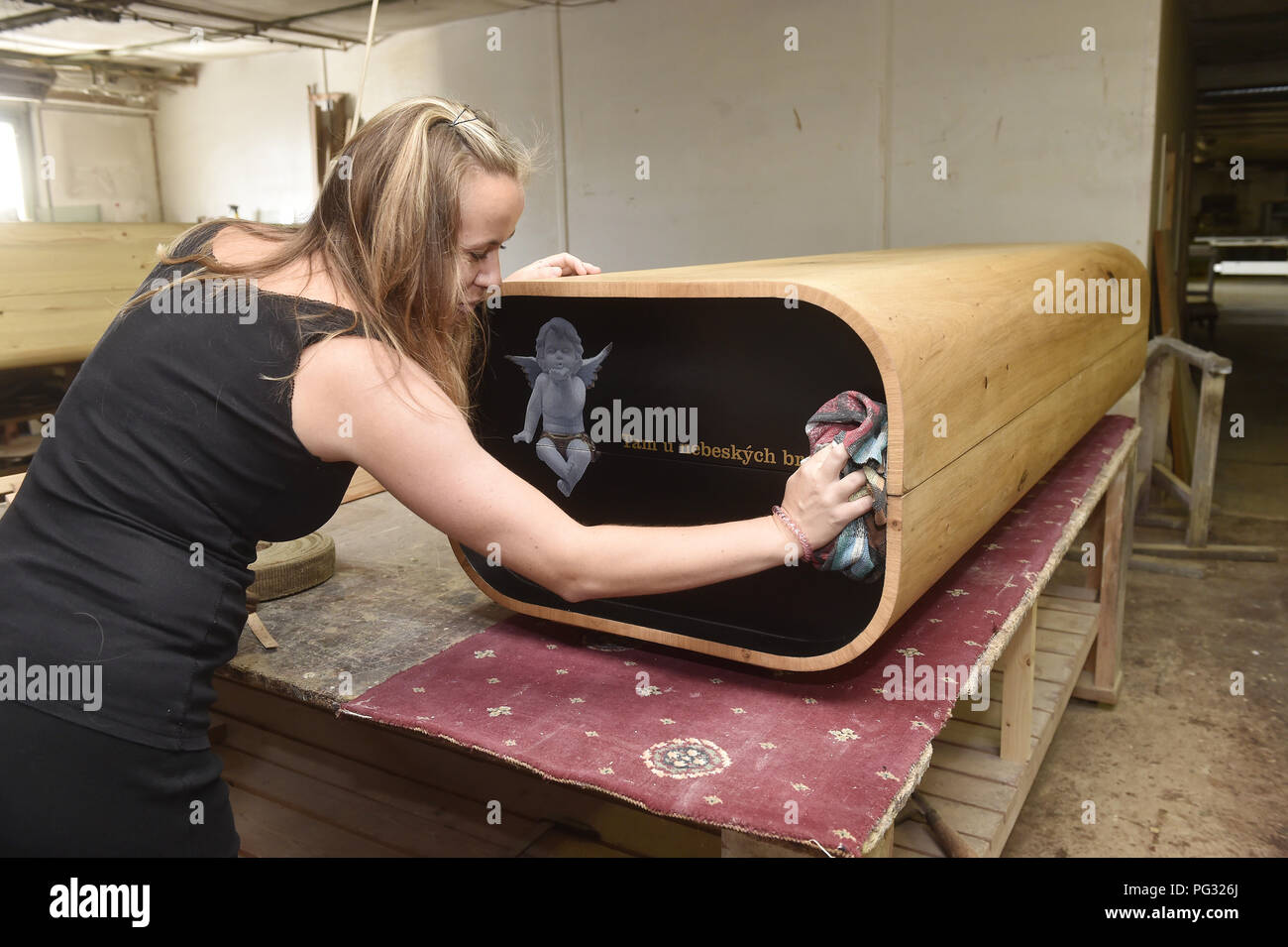 Velka Bystrice, Czech Republic. 21st Aug, 2018. Designer Jiri Duris, 53, has entered the sphere of funeral services with his latest design called Optimistic coffin and the motto For Design Lovers Beyond The Grave! Funeral services will soon receive its catalogue with an unorthodox offer of modern coffins. On the photo works product manager Dana Strniskova, in Velka Bystrice, Czech Republic, on August 21, 2018. Credit: Ludek Perina/CTK Photo/Alamy Live News Stock Photo