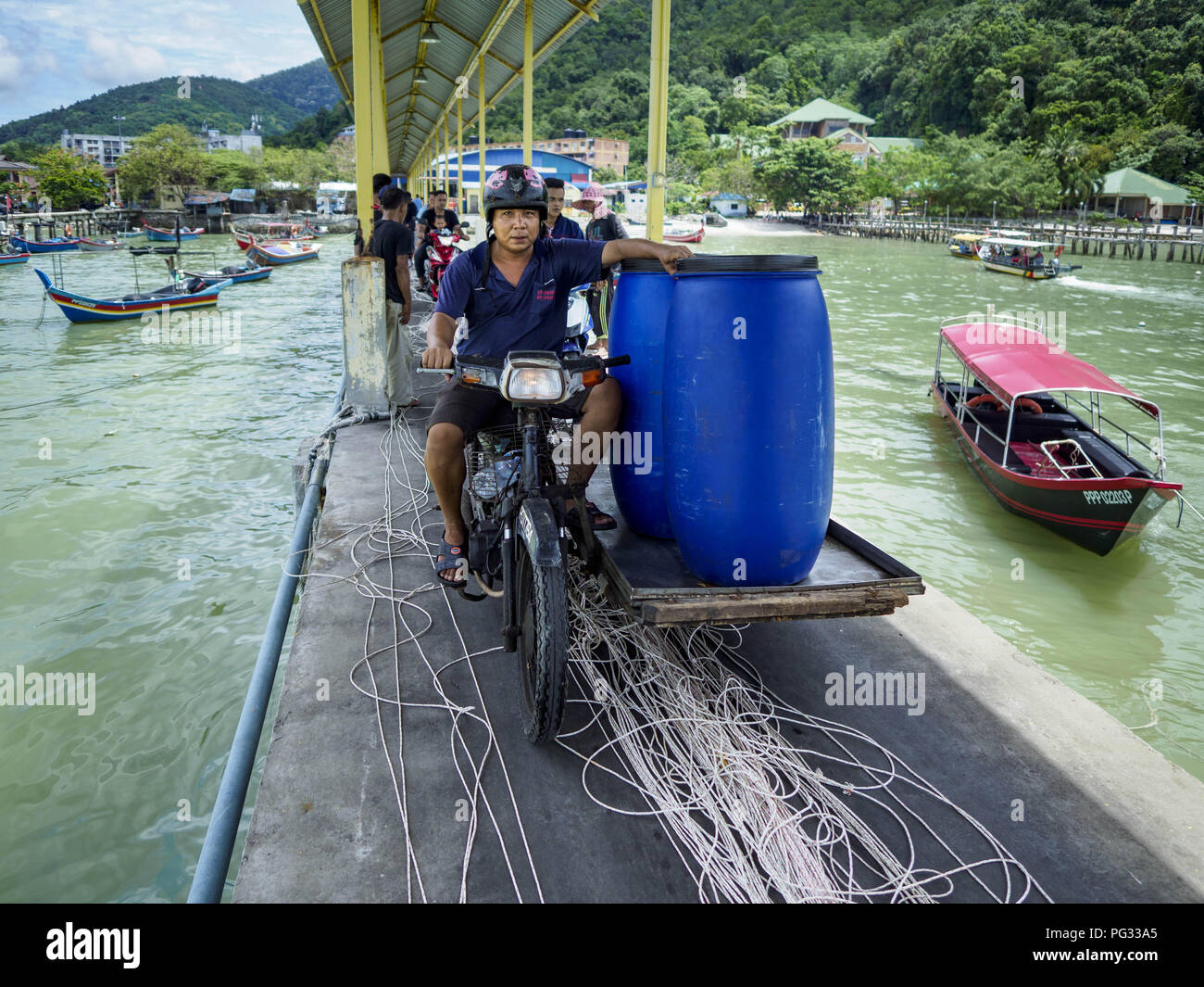 Teluk Bahang Penang Malaysia 23rd Aug 2018 A Motorcycle Hauls Supplies Out To Commercial Fishing Trawlers In Port In Teluk Bahang On The Island Of Penang Fishermen On Penang An Island Off