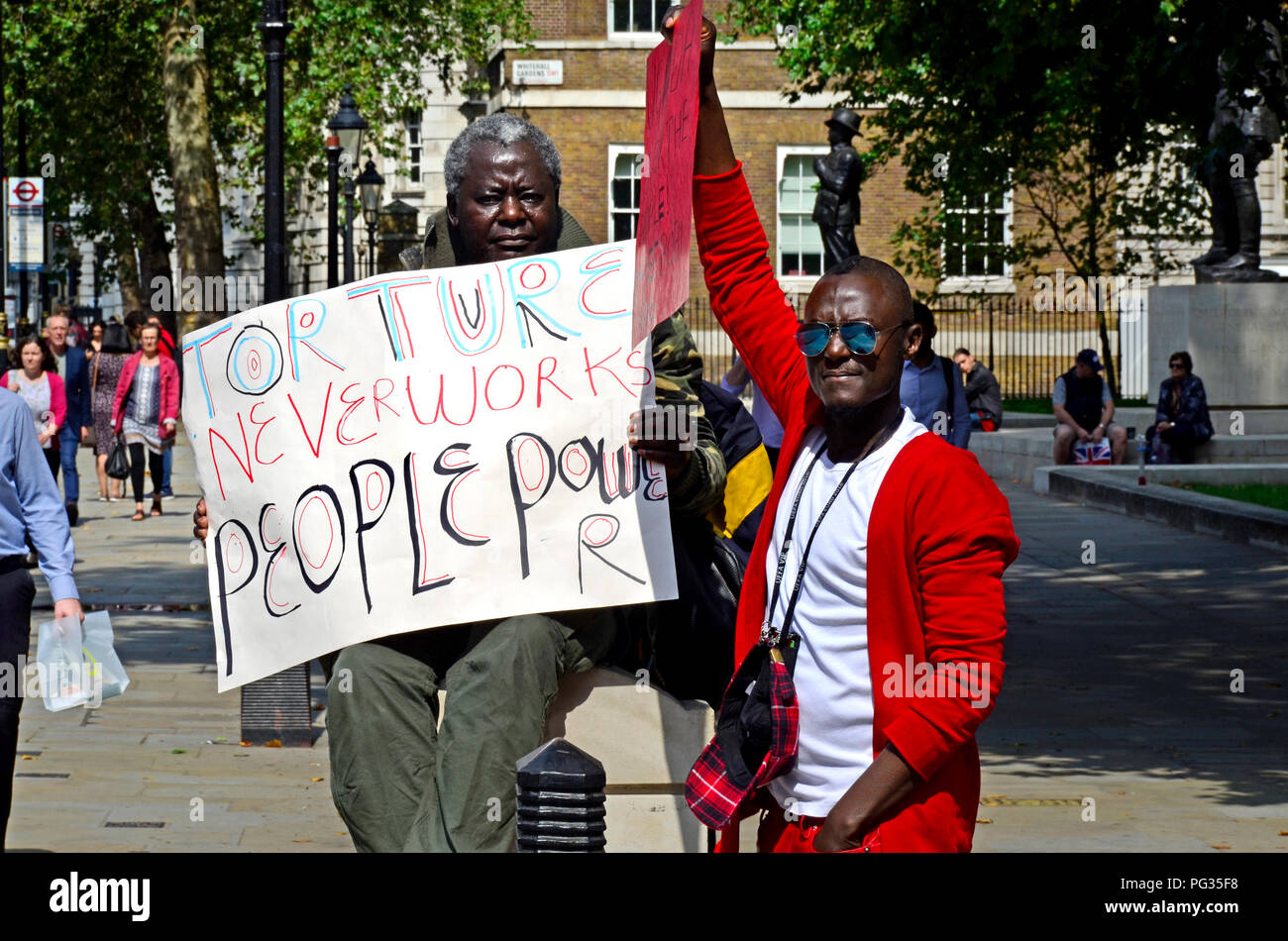 London, 23rd August 2018. Campaigers protest in Whitehall opposite Downing Street against Ugandan President Museveni and in support of Bobi Wine (Robert Kyagulanyi Ssentamu, also known as Bobi Wine, Ugandan politician, musician and actor) who was rearrested in Uganda on charges of treason, moments after the state had withdrawn previous charges of illegal possession of firearms and ammunition. Credit: PjrFoto/Alamy Live News Stock Photo