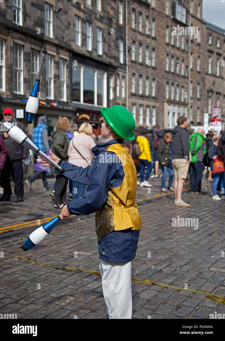 Edinburgh, Scotland, UK 23 August 2018. Edinburgh Fringe Festival, Royal Mile, 12 year old Patrick from Edinburgh plays with fire with his juggling act appearing at his first Fringe as a busker Stock Photo