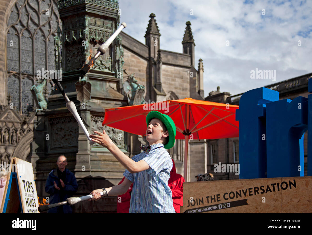 Edinburgh, Scotland, UK 23 August 2018. Edinburgh Fringe Festival, Royal Mile, 12 year old Patrick from Edinburgh plays with fire with his juggling act appearing at his first Fringe as a busker Stock Photo