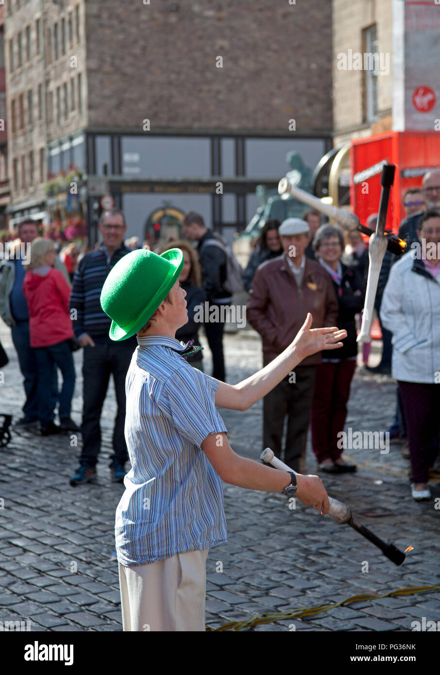 Edinburgh, Scotland, UK 23 August 2018. Edinburgh Fringe Festival, Royal Mile, 12 year old Patrick from Edinburgh plays with fire with his juggling act appearing at his first Fringe as a busker Stock Photo