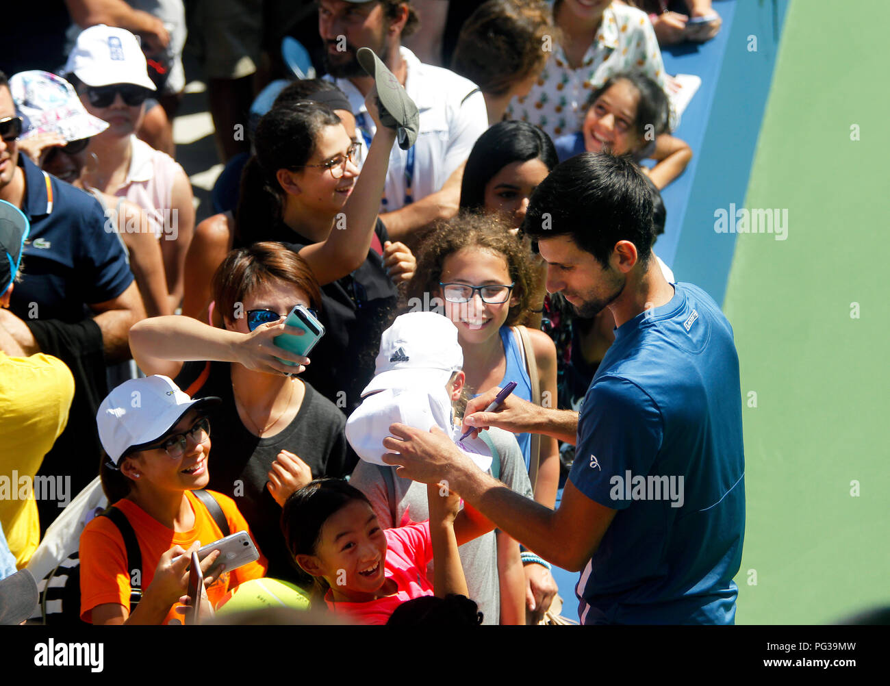 New York, United States. 23rd Aug, 2018. New York, N.Y, August 23, 2018 - US Open Tennis Practice: Novak Djokovic signs autographs for fans after practicing at the Billie Jean King National Tennis Center in Flushing Meadows, New York, as players prepared for the U.S. Open which begins next Monday. Credit: Adam Stoltman/Alamy Live News Stock Photo