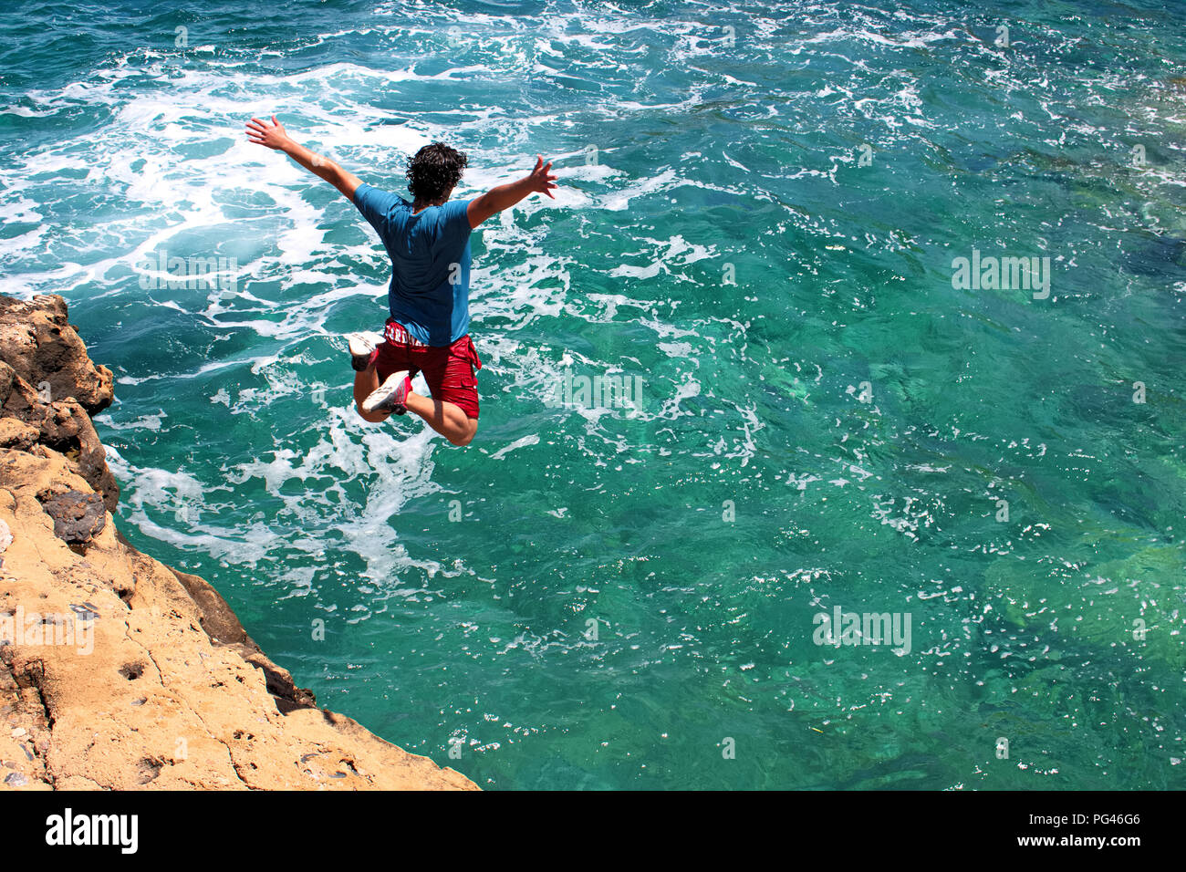 Making the leap cliff jumping in Greece Freedom Stock Photo