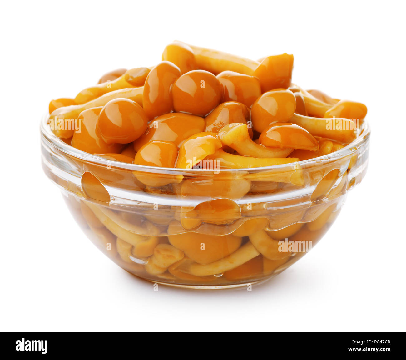 Pickled mushrooms in glass bowl isolated on white Stock Photo