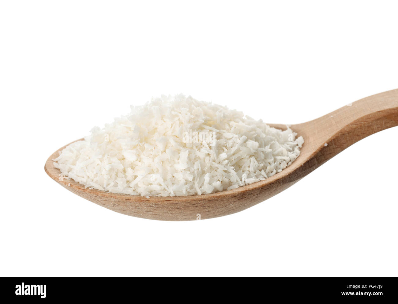 Close up of wooden spoon with coconut shavings isolated on white Stock Photo
