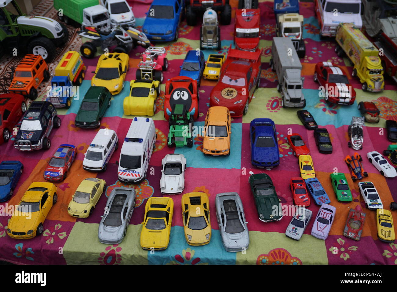 Colorful vintage car toys for sale at the outdoor market in the street in France Stock Photo