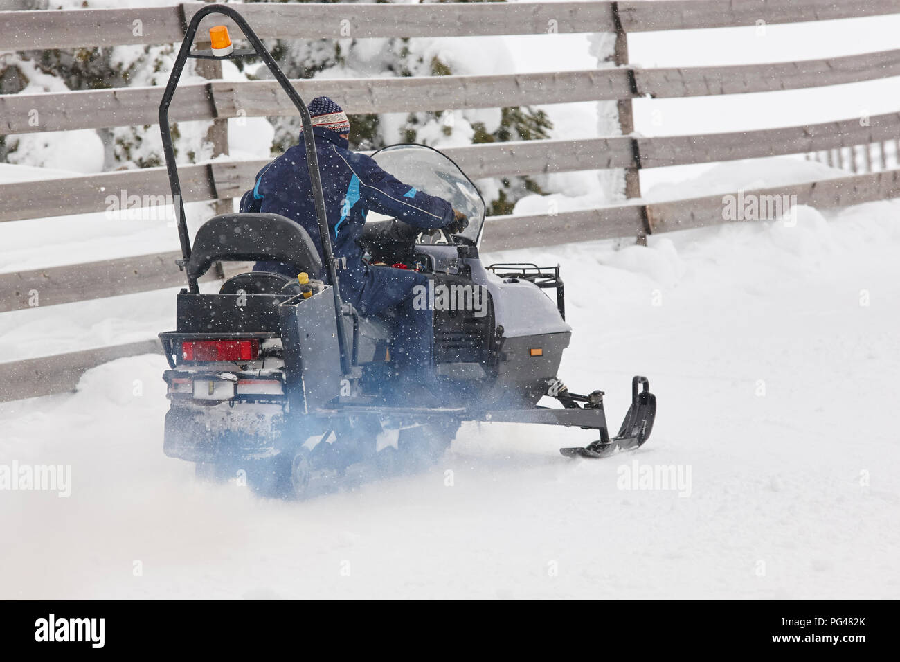 Snowmobile under the snow. White winter mountain landscape. Horizontal