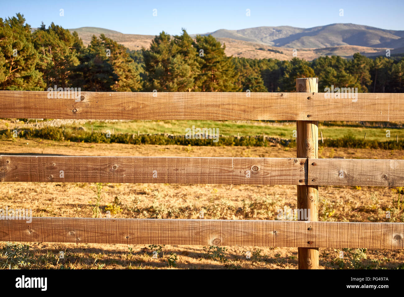 Wood fence on a countryside background Stock Photo - Alamy