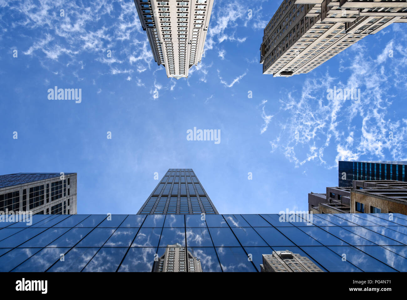New York City, USA - June 21, 2018: Low angle view of 432 Park Avenue building and other skyscrapers against blue sky Stock Photo