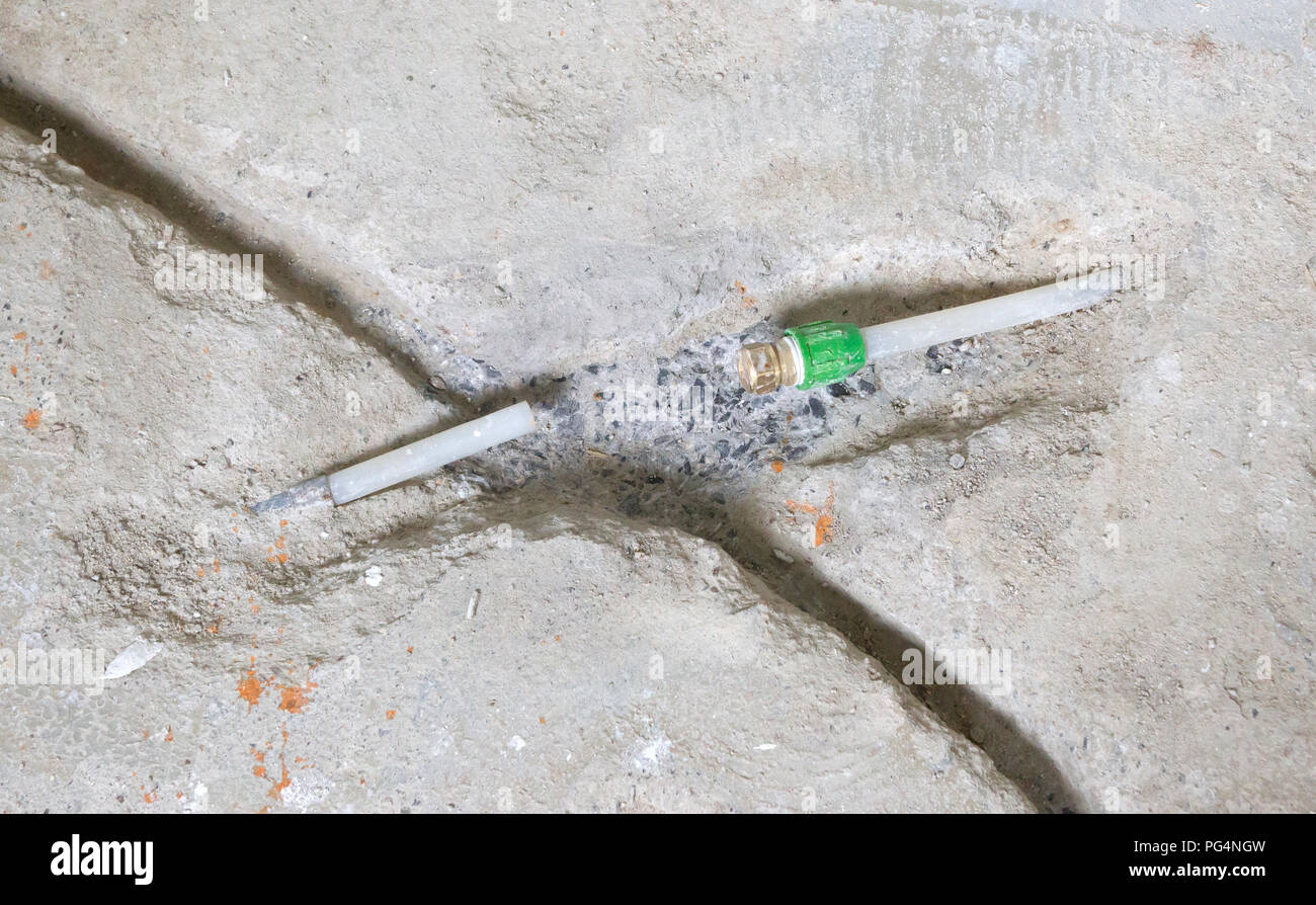 Repairing a broken water pipe in the concrete floor Renovation Stock