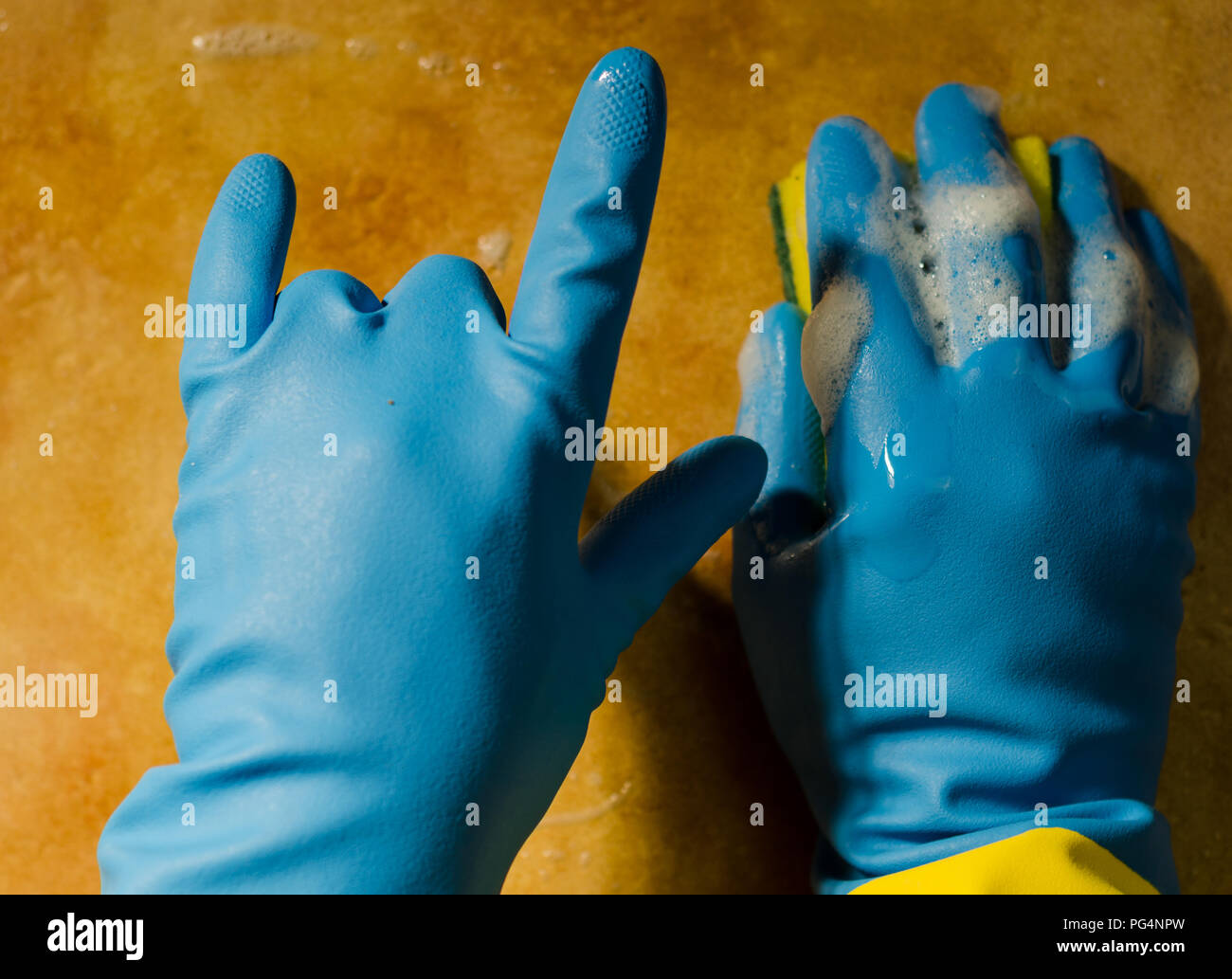 hands in rubber gloves cleaning the surfaces of ceramic tiles, safe and