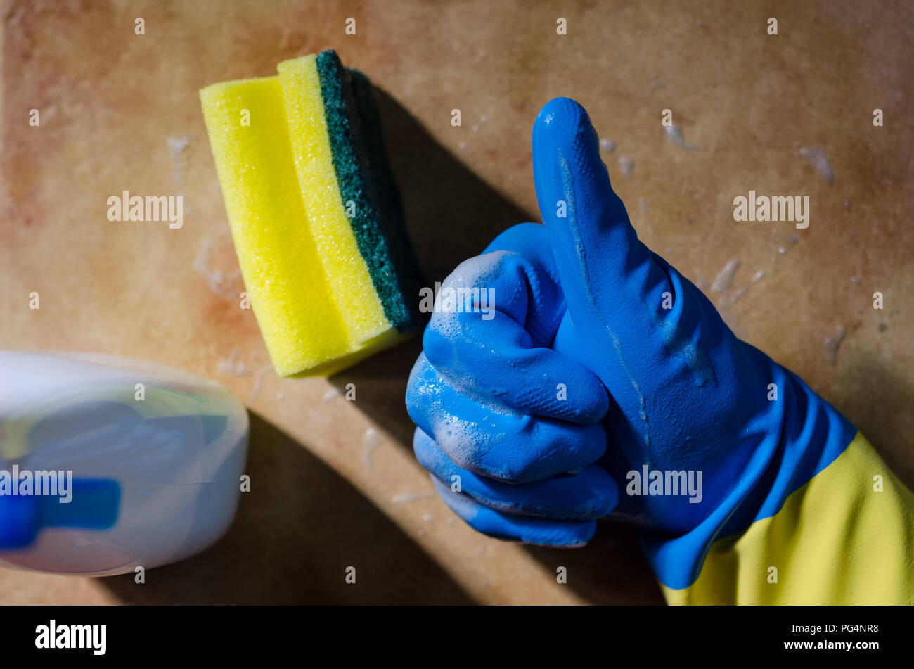 hands in rubber gloves cleaning the surfaces of ceramic tiles, safe and