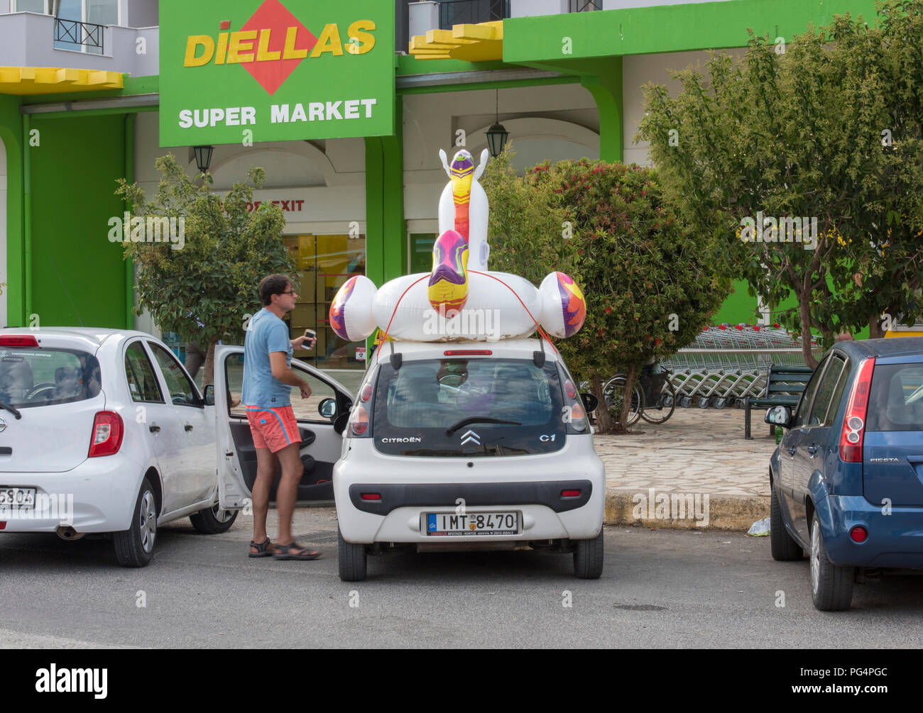 a large inflatable toy on the roof rack 