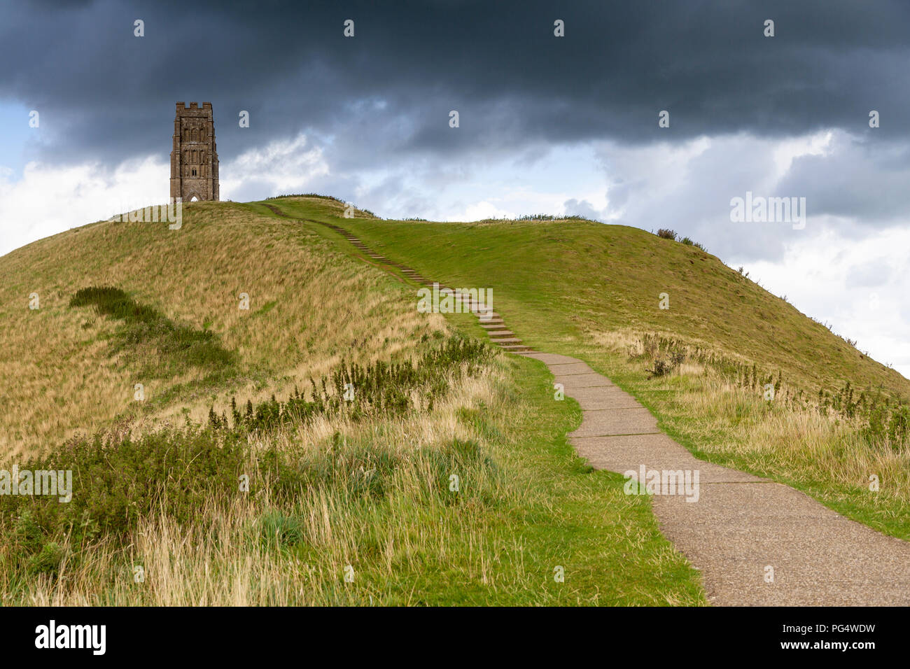 St Michaels Tower and Glastonbury Tor under a stormy sky. Stock Photo
