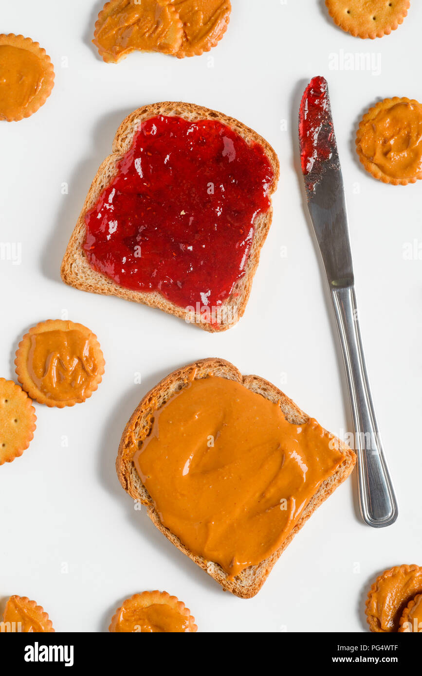 Delicious traditional jam and peanut butter sandwich, topview. Knife