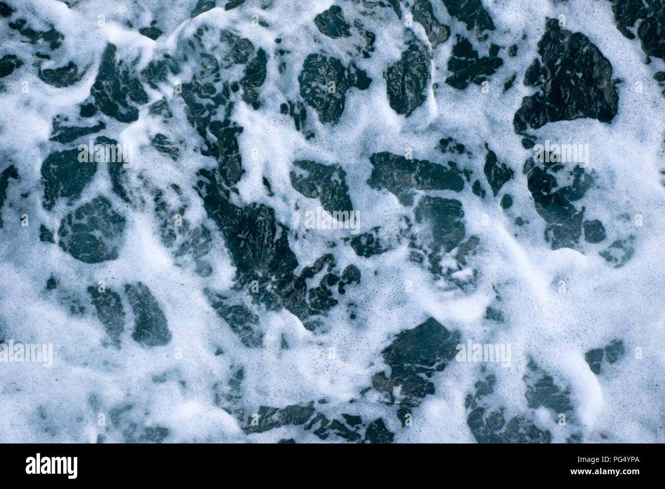 a macro shot of sea water creating interesting patterns as it hits the side of a ship. Stock Photo