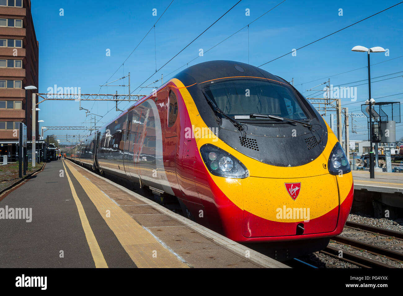 Virgin Trains pendolino class 390 electric high speed train arriving at a railway station on the Abbey Line, Hertfordshire, UK. Stock Photo