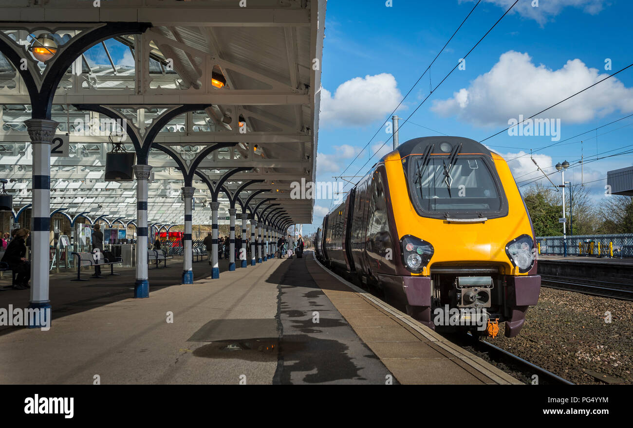 Class 220 Voyager passenger train in CrossCountry livery at a platform at a railway station on the east coast main line, England. Stock Photo