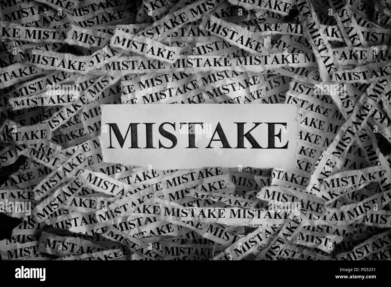 Mistake. Torn pieces of paper with the word Mistake. Concept Image. Black and White. Closeup. Stock Photo