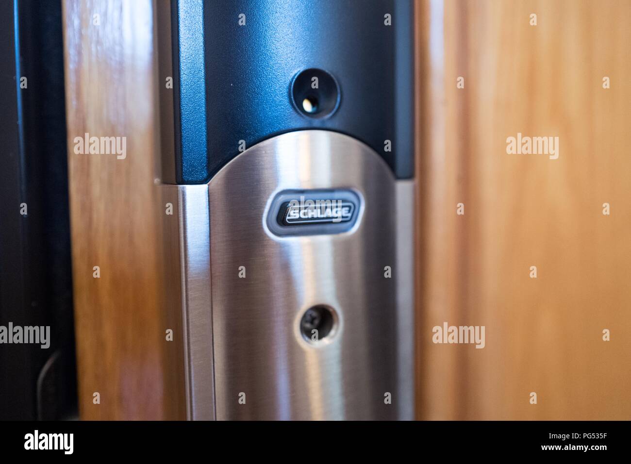 Close-up of Schlage Connect smart lock installed on the front door of a home, a smart home device which allows the door to be unlocked remotely from a smartphone app, May 7, 2018. () Stock Photo