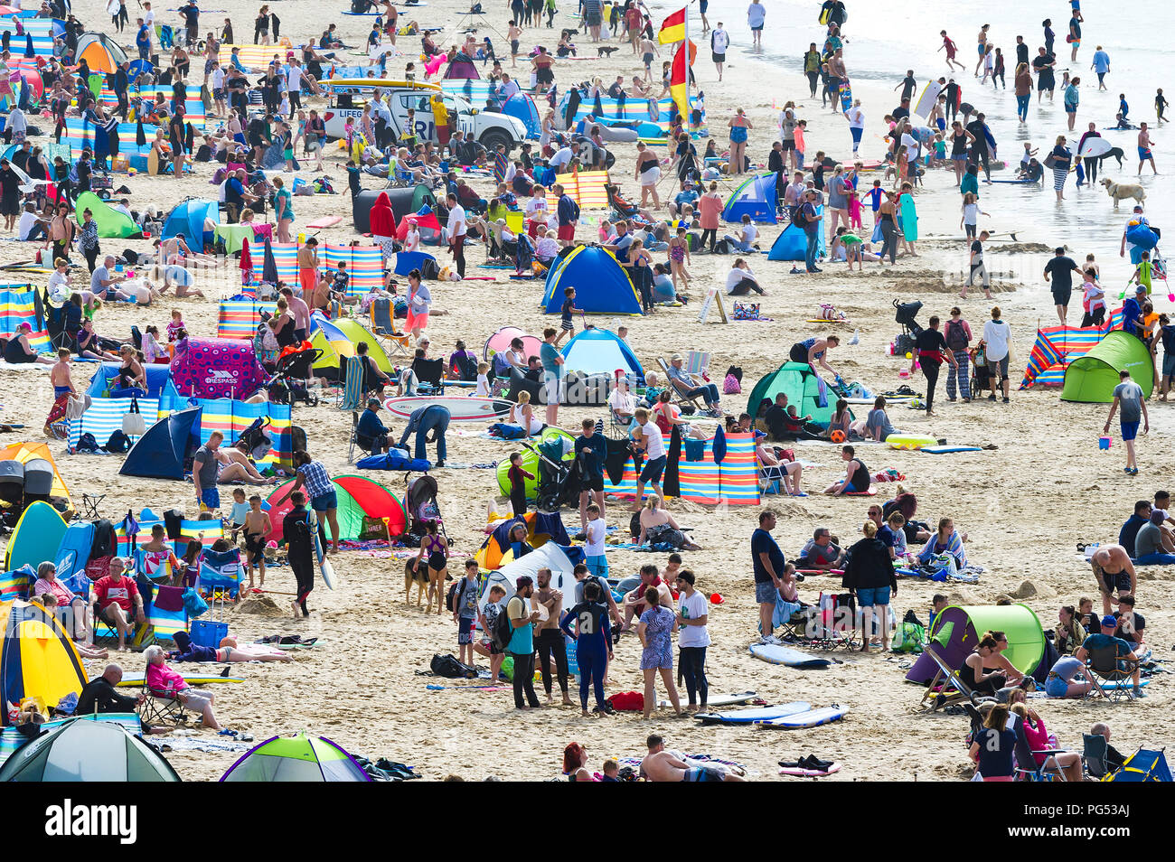Holidaymakers on a busy crowded Fistral Beach in Newquay Cornwall. Stock Photo
