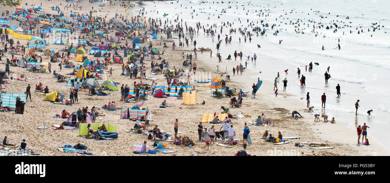 A panoramic view of a very busy Fistral Beach during the Summer holidays Cornwall. Stock Photo