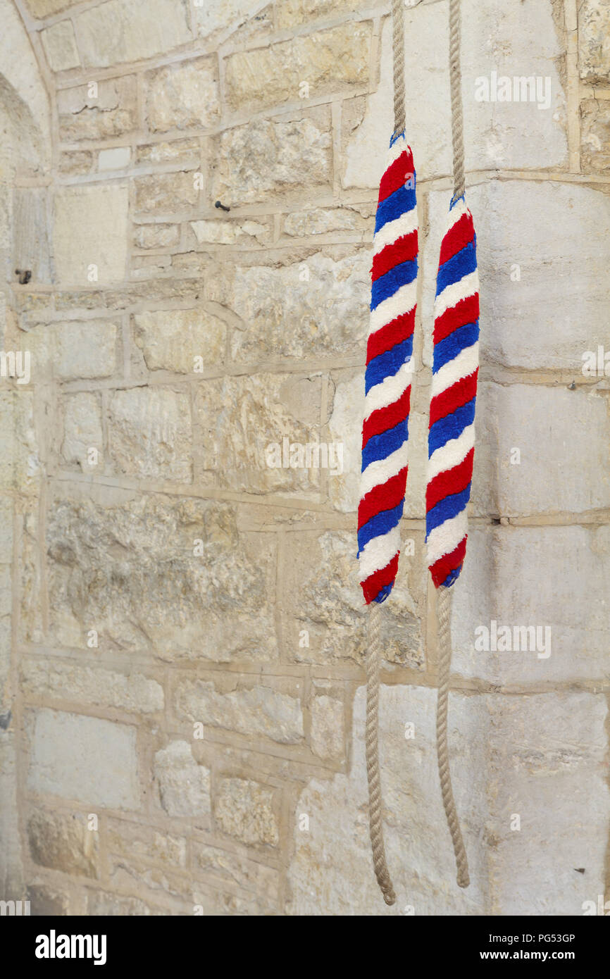 Ropes for ringing bells in an ancient church in England, UK. With copy space, depicts campanology and Christianity Stock Photo