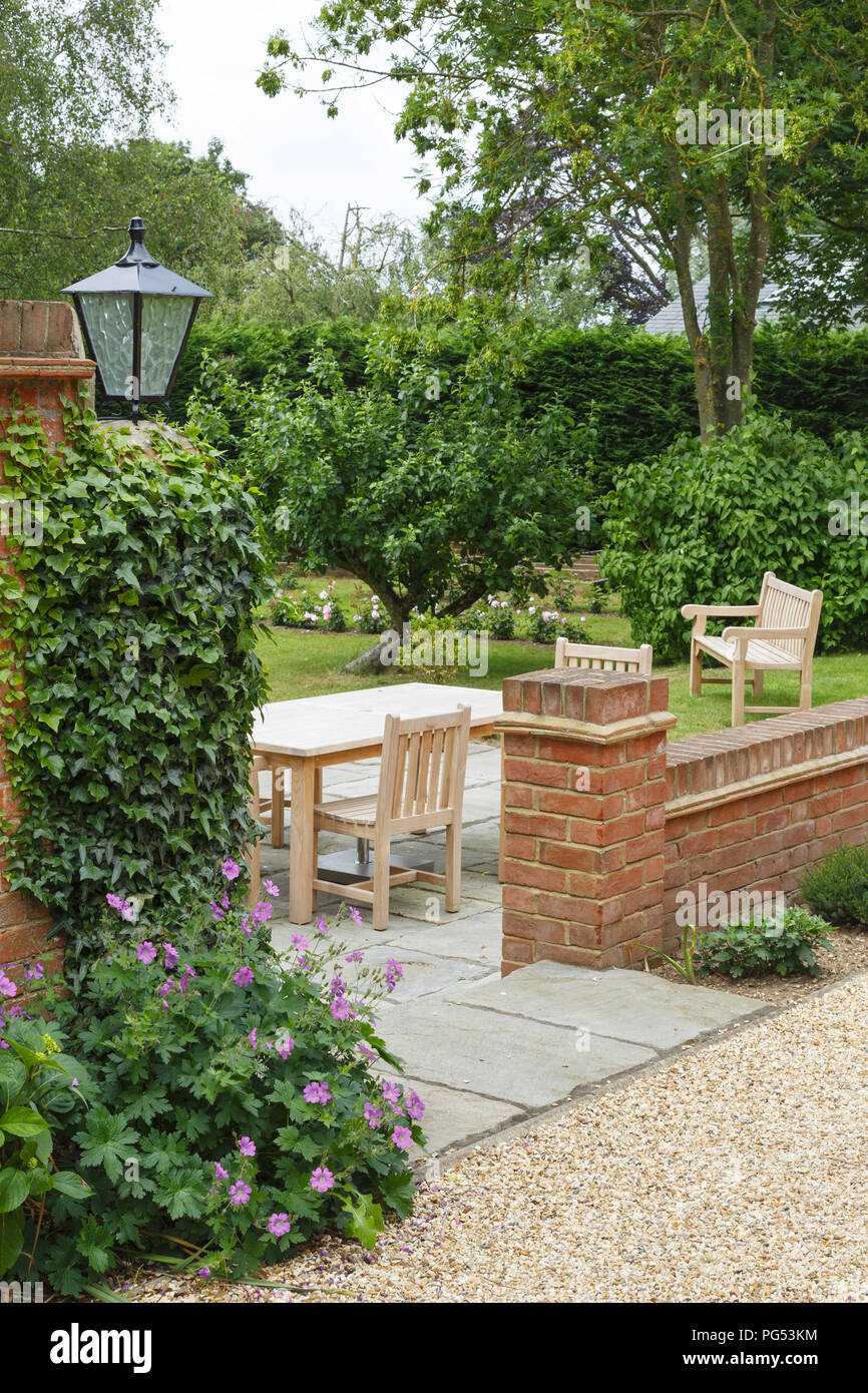 English UK garden in summer with patio and garden furniture Stock Photo