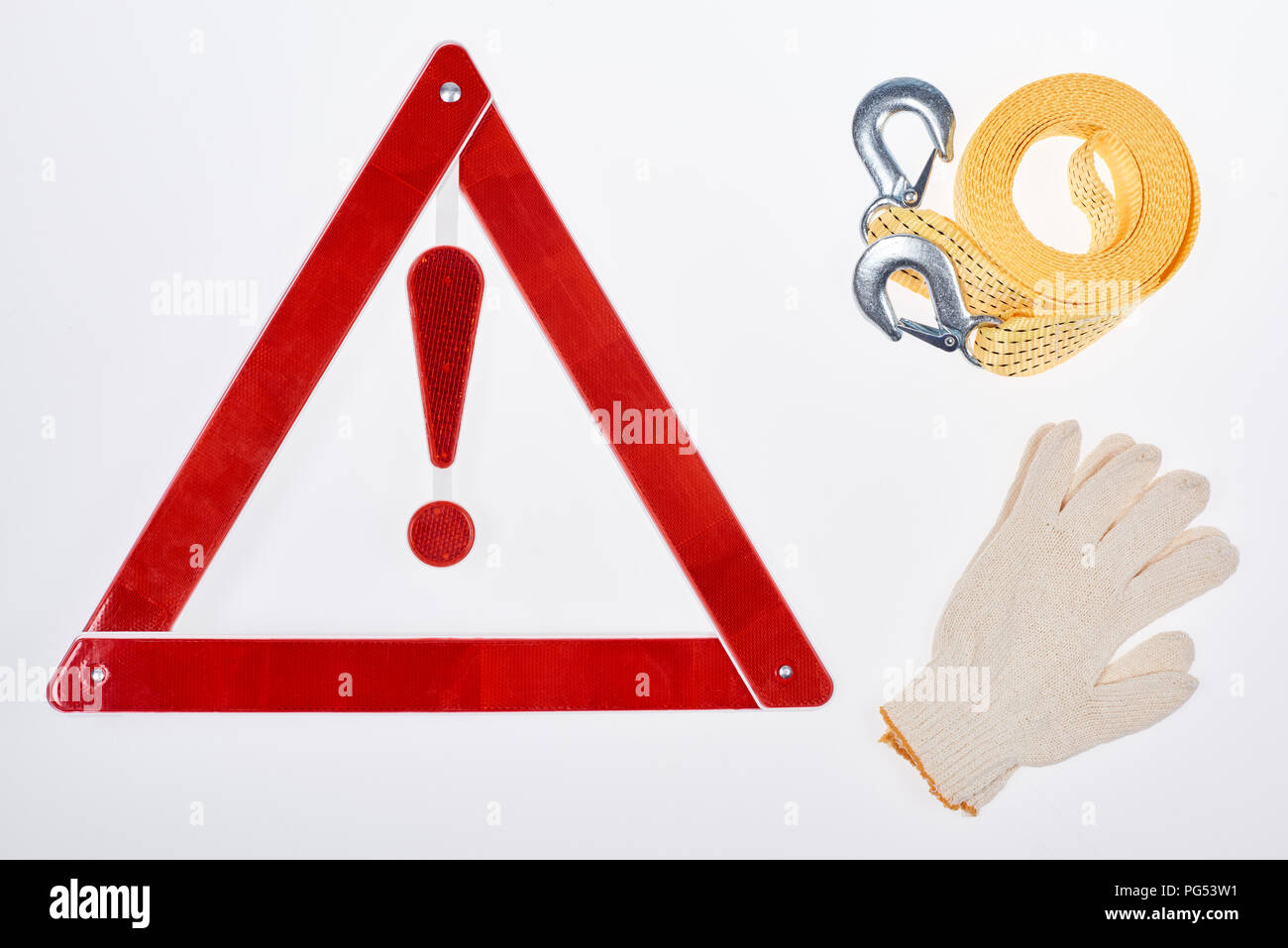 flat lay with warning triangle, gloves and car tow rope isolated on white Stock Photo