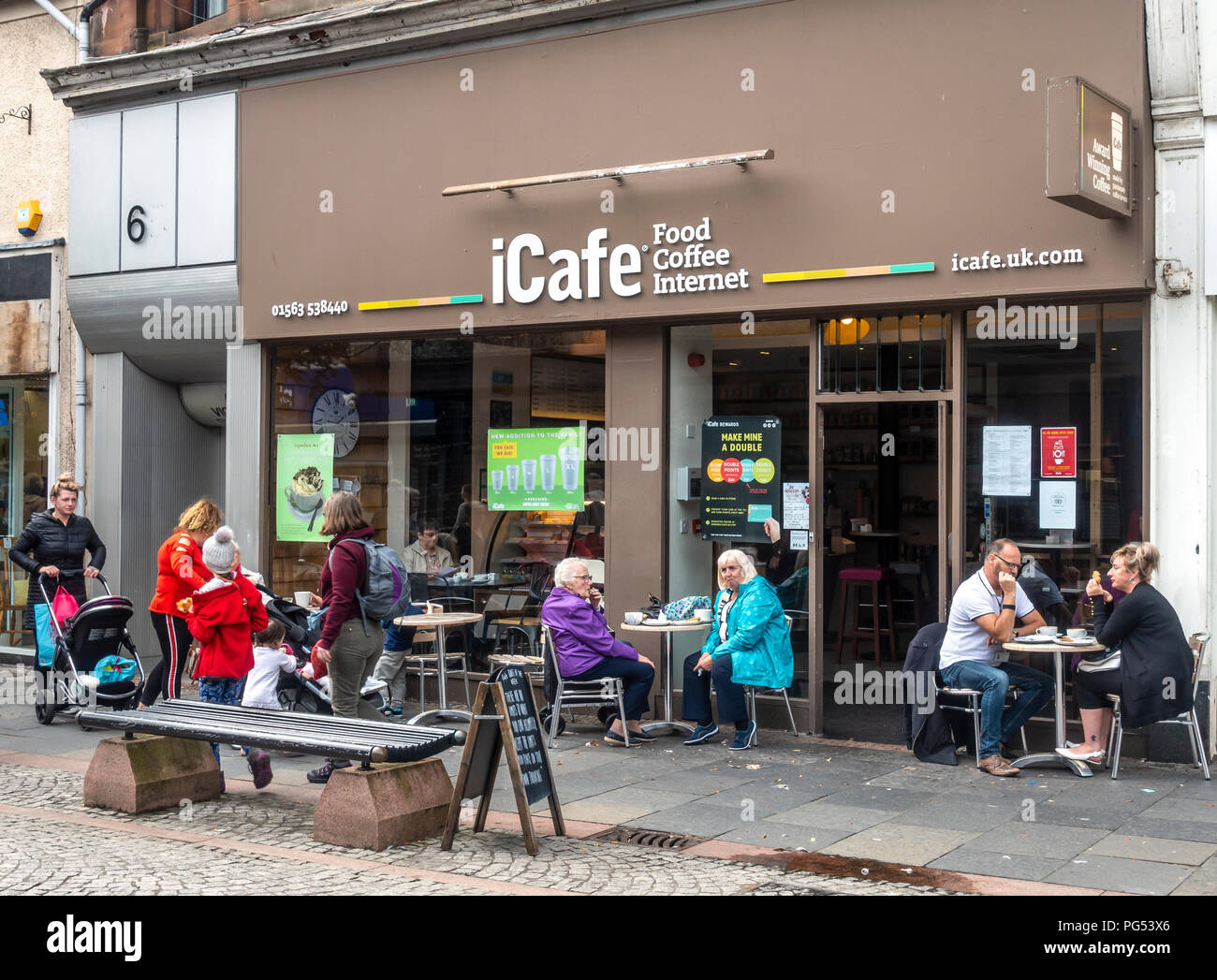 Customers sitting at tables outside the iCafe coffee house and