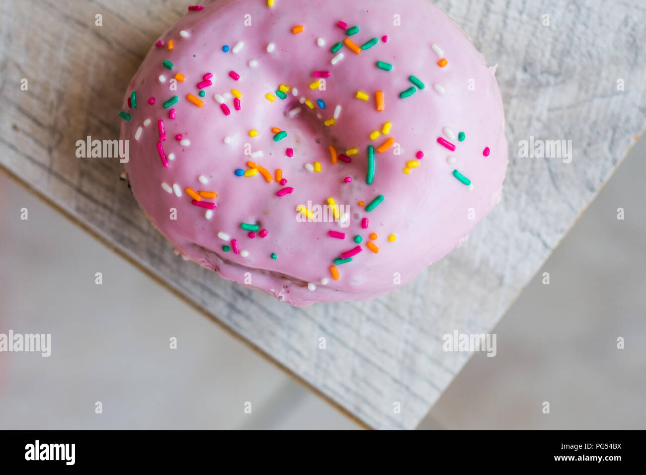 Pink donut with sprinkles Stock Photo Alamy