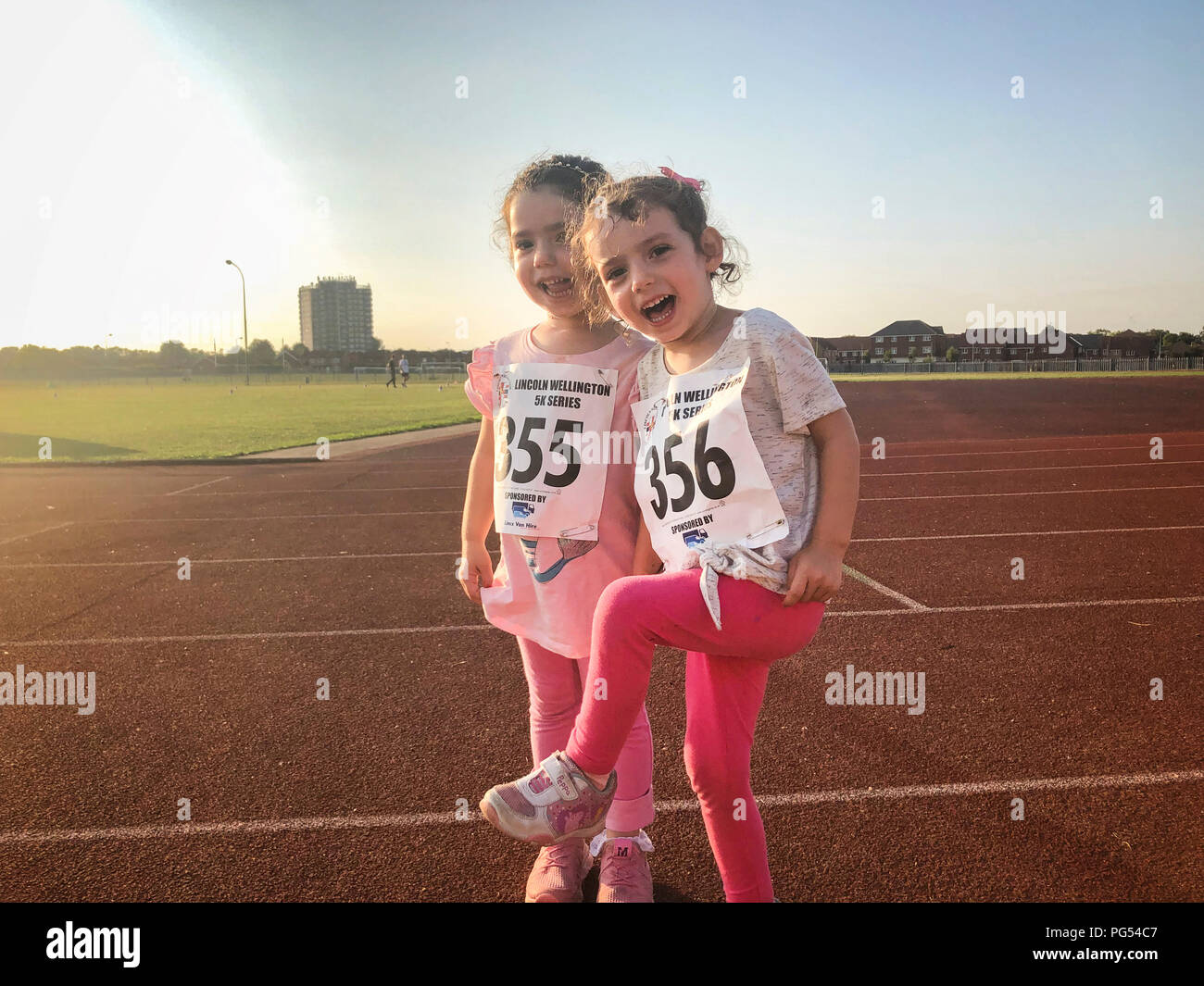 Young girls running together. Credit Lee Ramsden - Alamy Stock Photo