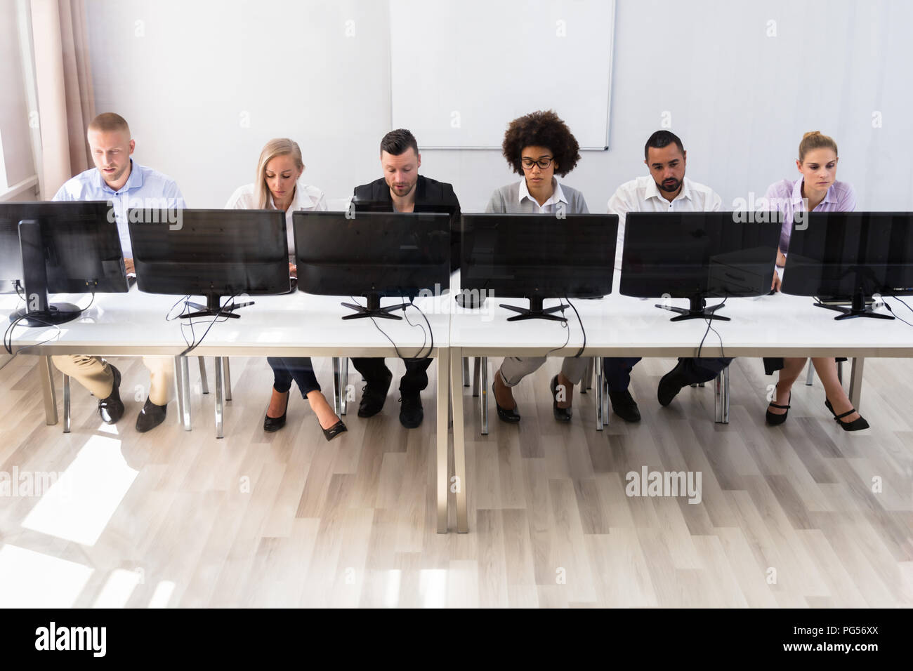 Skilled Young Business Executives Working On Computer In Office Stock Photo