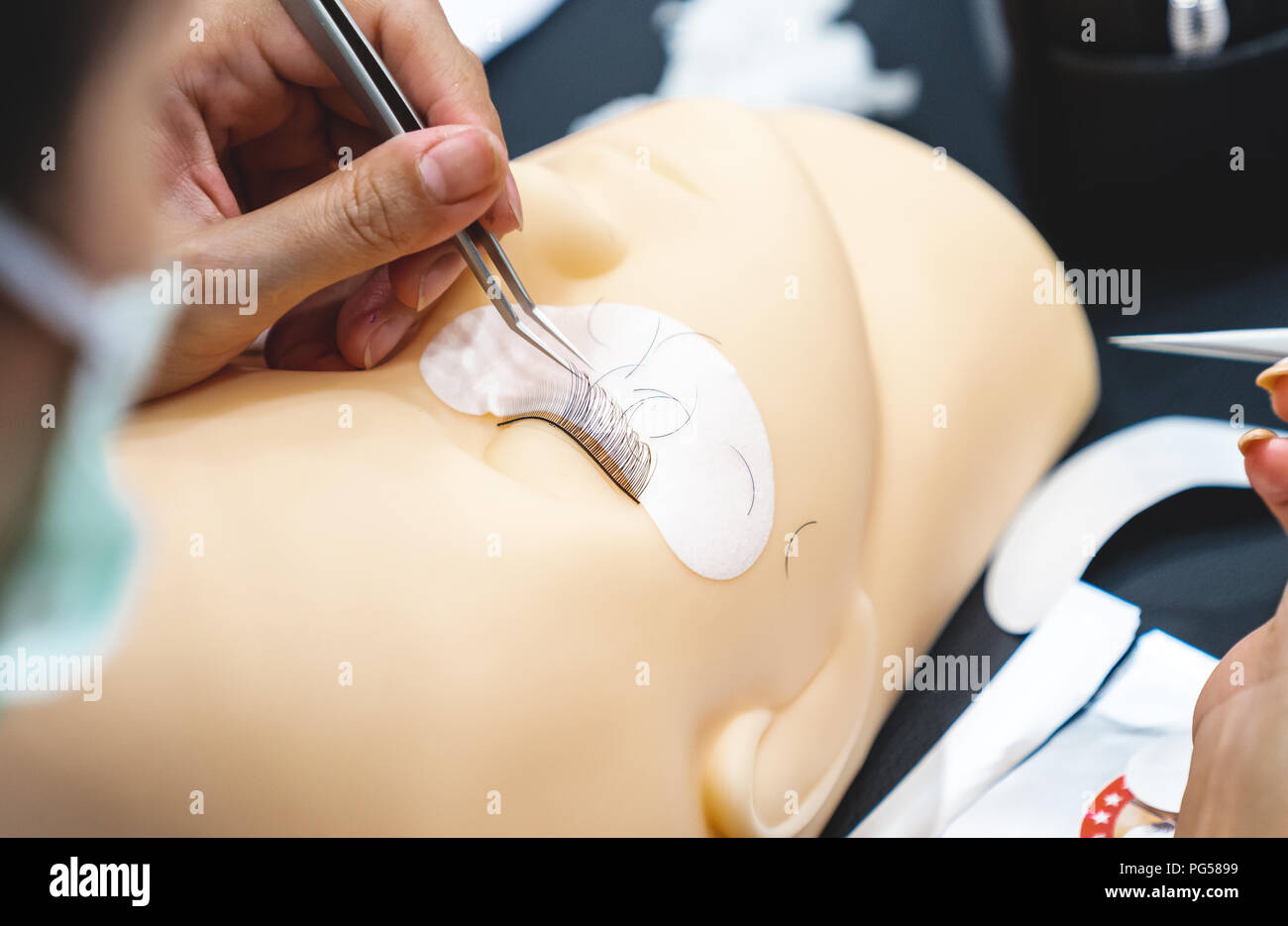 close up training for permanent eyelash extension on Silicone Mannequin Head , study and skill, Work with tweezers Stock Photo