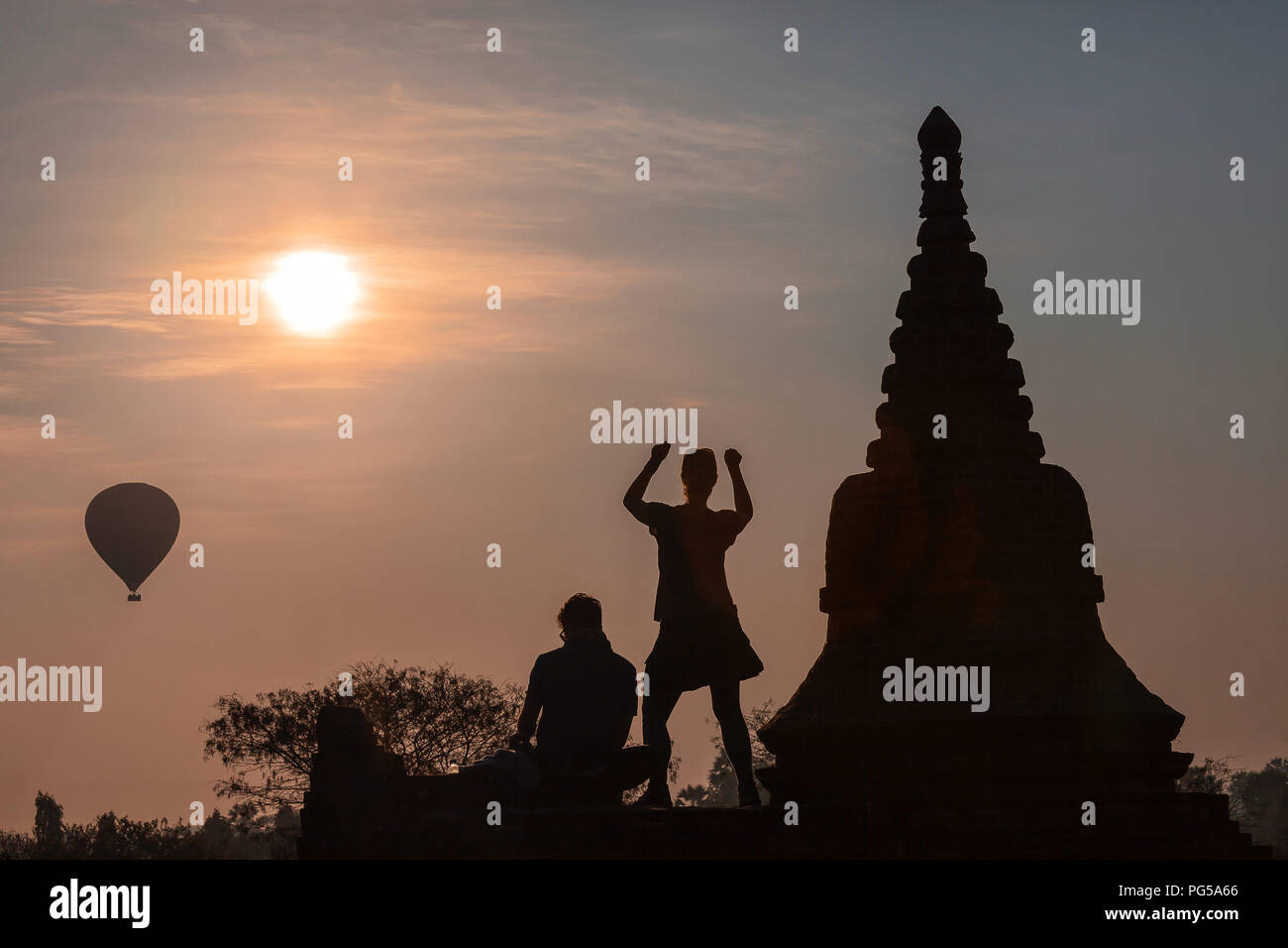 Dancing girl and Hot air balloons over plain of Bagan in misty morning, Myanmar Stock Photo